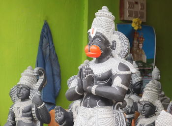 Statue of toy against wall and building