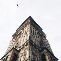 Low angle view of town hall tower against sky