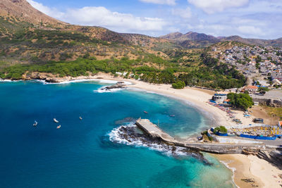 Aerial view of sea and mountains against sky