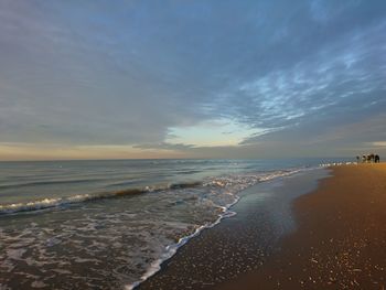 Scenic view of beach against sky during sunset