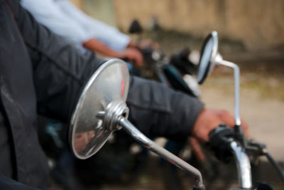 Close-up of hand holding motorcycle