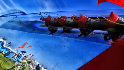 Close-up of airplane against blue sky