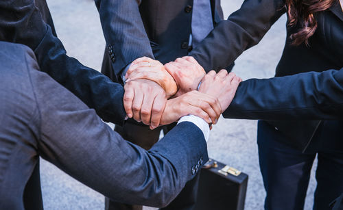 High angle view of business people forming hand chain