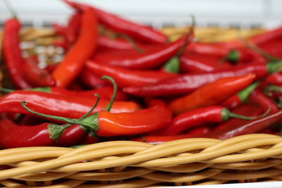 Close-up of red chili peppers in basket