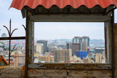 Buildings in city against sky framed