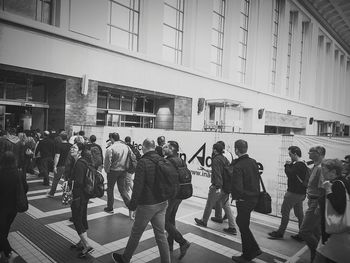 Group of people walking on street in city