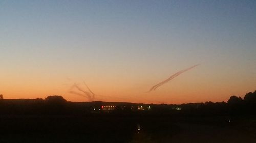 Silhouette landscape against sky during sunset