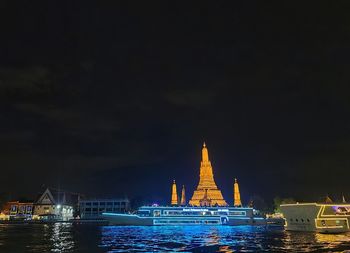 Illuminated buildings by city at night