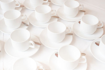 Group of coffee cups in cafe bar on the white tablecloth