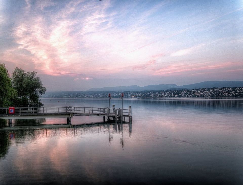 water, sunset, sky, waterfront, tranquil scene, cloud - sky, tranquility, reflection, scenics, built structure, pier, beauty in nature, lake, river, architecture, nature, cloud, bridge - man made structure, idyllic, dusk