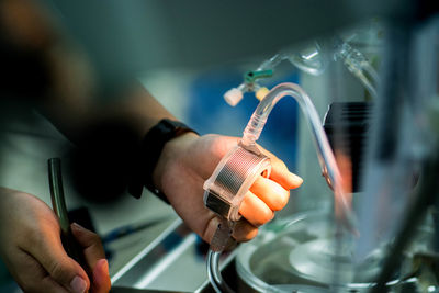 Cropped hands of doctor holding medical equipment in hospital