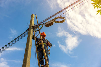 Low angle view of electricity pylon against sky