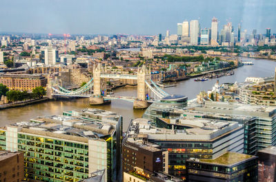 High angle view of river amidst buildings against sky