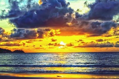 Scenic view of sea against orange sky