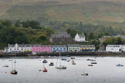 Boats in river with buildings in background