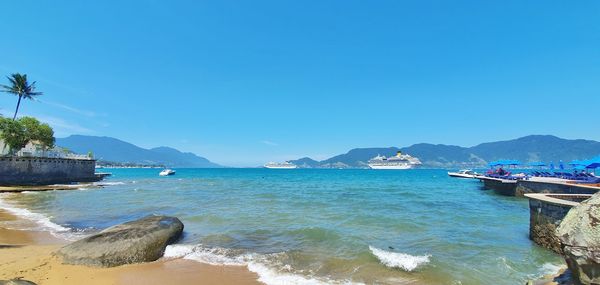 Scenic view of sea against clear blue sky