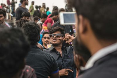 Close-up of man photographing with mobile phone