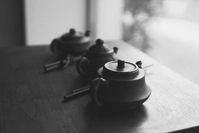 Close-up of teapots on table