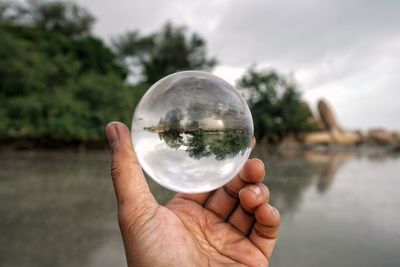 Close-up of hand holding glass of water