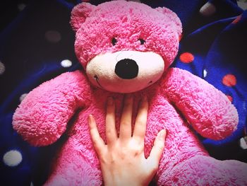 Close-up of hand with pink toy