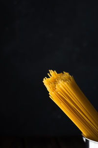 Close-up of yellow leaf against black background