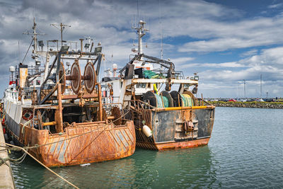 Two old and rusty fishing boats moored in howth harbour, dublin, ireland