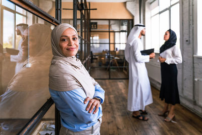 Low angle view of young woman standing in office