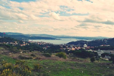 Scenic view of landscape against cloudy sky