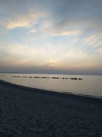 Scenic view of beach against sky during sunset