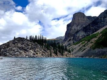 Scenic view of sea and mountains against sky