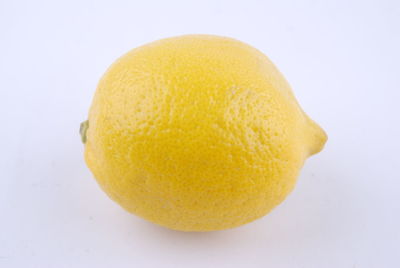 Close-up of orange slice against white background