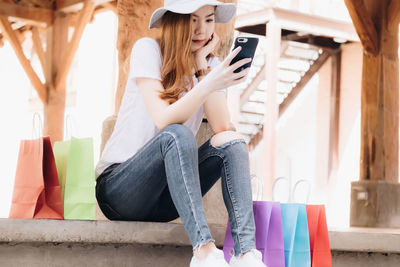 Midsection of woman sitting in corridor