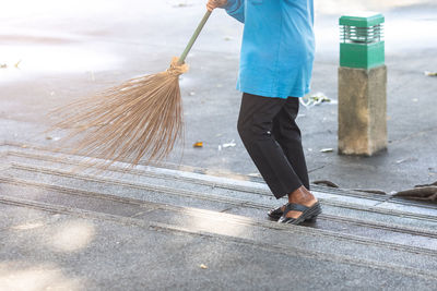 Low section of man walking on road