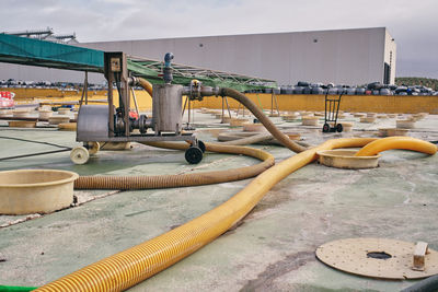 Metal construction with water and pipes placed in industrial area with tanks for purification of raw material at factory