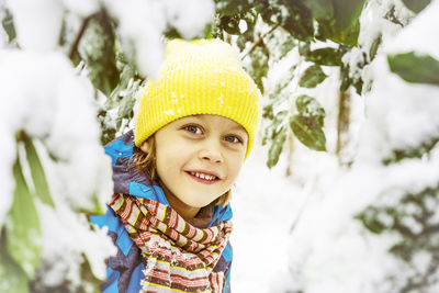 Portrait of smiling boy wearing knit hat during winter