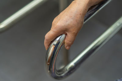 Close-up of hand on metal