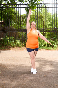 Full length of woman exercising in park