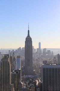 Modern buildings in city against clear sky