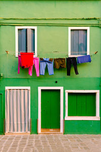 Clothes drying outside house against building