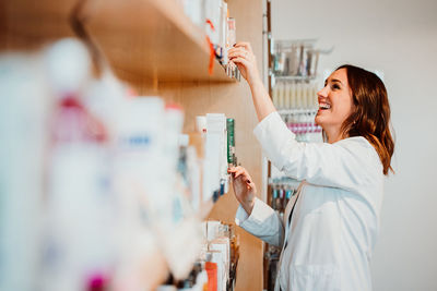 Smiling female pharmacist working at store