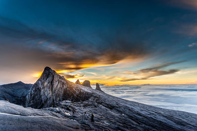 Scenic view of snowcapped mountains against sky during sunset