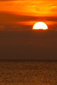 Scenic view of sea against orange sky