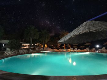 Swimming pool against sky at night