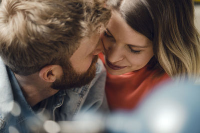 Affectionate couple cuddling at home