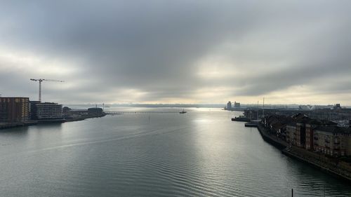 Scenic view of harbor by sea against sky