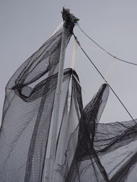 Low angle view of fishing net against clear sky