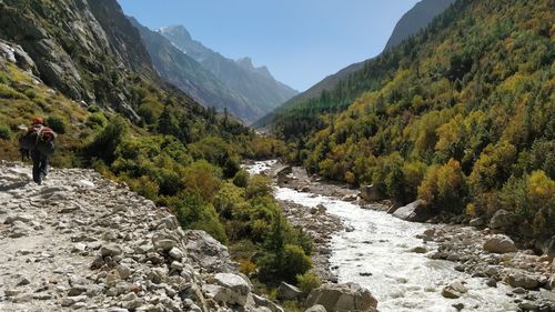 Scenic view of river amidst mountains against sky