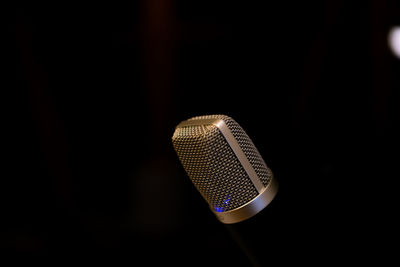 Close-up of electric bulb against black background