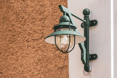 Low angle view of electric lamp on wall