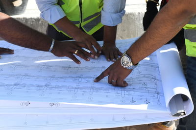 High angle view of people working on table